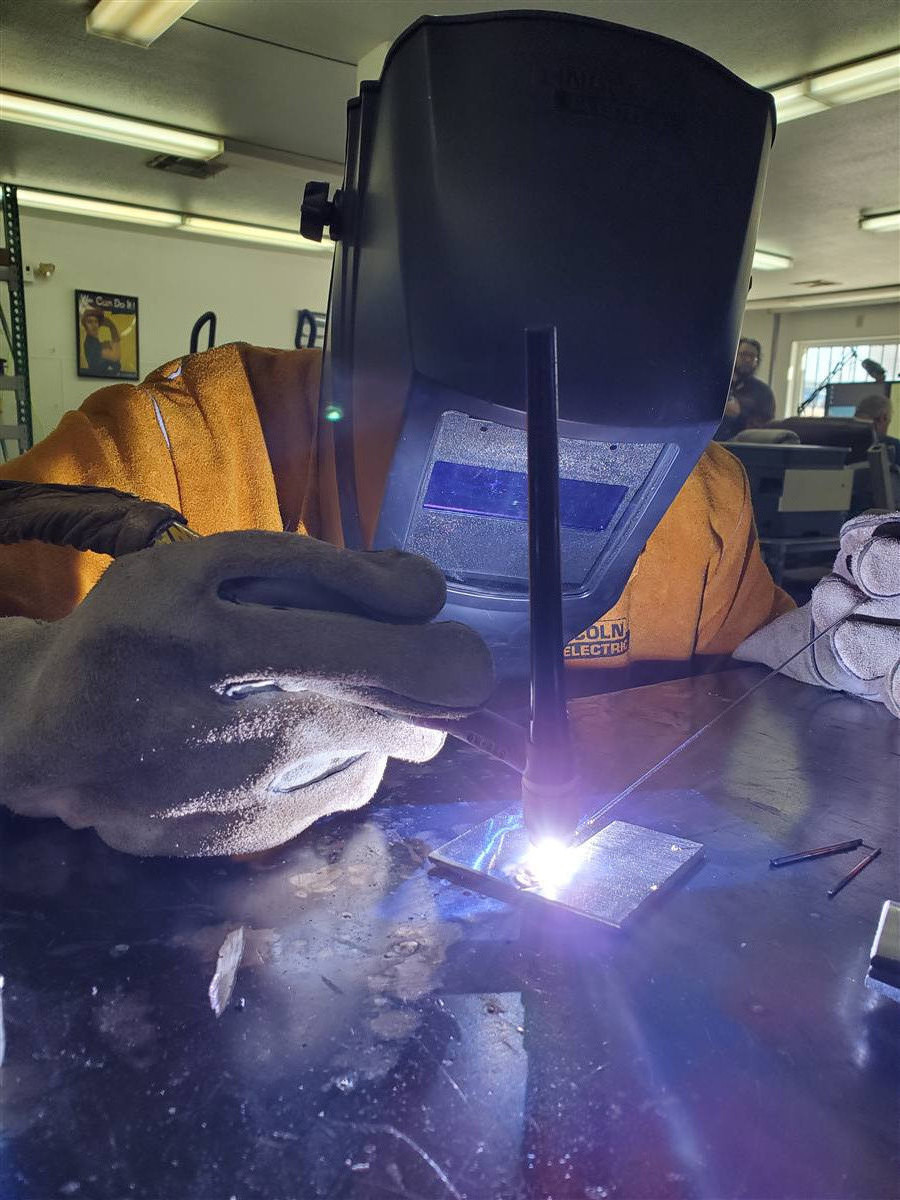 Student TIG welding a test plate at the Welding Nevada school in Las Vegas